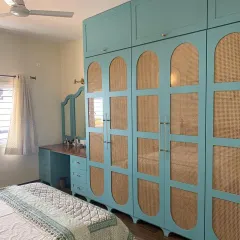 Teal out here stealing the show! This vintage-chic wardrobe combines a beautiful teal color with cane webbing and arched details for a truly unique look.