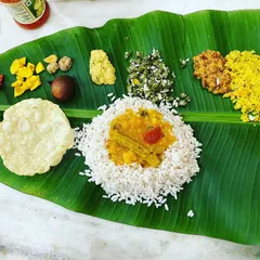 A closer look at the Onam Sadhya, a vegetarian feast that is central to my culinary events. Each dish is carefully prepared to create a balanced and harmonious meal, served authentically on a banana leaf.