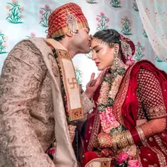 A tender and symbolic moment from a wedding ceremony. The groom's kiss on the bride's forehead is a classic shot that we capture with reverence and artistry.