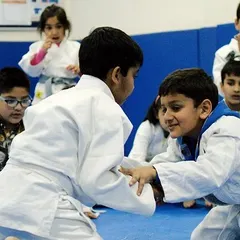 Two young students practice grappling techniques. Learning to control an opponent on the ground is a fundamental part of real self-defense.