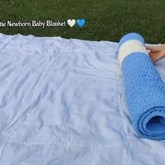 Rolling up the softie newborn baby blanket, perfect for gifting.