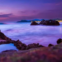 Using a long exposure technique, I smoothed out the waves to create this magical, misty effect on the water. The purple and pink hues of the twilight sky give it an aurora-like vibe.