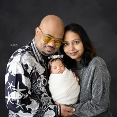 A classic portrait of mom and dad with their precious newborn. The love and pride in their expressions is what makes these photos so powerful.