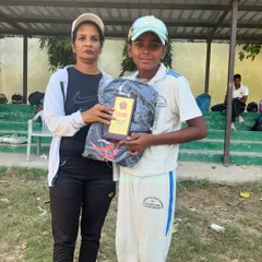 Chirag Upadhyay proudly holds his award after scoring a magnificent 100 not out.
