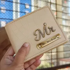 A cream-colored, croc-textured faux-leather wallet. This one is customized with a "Mr" charm and a nameplate for "Mr. Micheal", showing a classic and respectful personalization style.