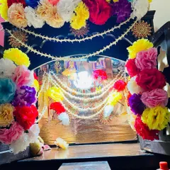 I decorate home mandirs to make them look special for any pooja or festival. This wooden mandir is decorated with colorful artificial flowers and traditional pearl strings.