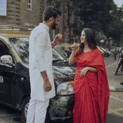 In the heart of South Bombay, we paused for a moment of quiet connection over cutting chai, with a classic kaali-peeli taxi framing this authentic, old-school romantic portrait.