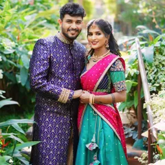 A beautiful couple, with her wearing one of our custom half sarees. The combination of a turquoise skirt and a pink and blue blouse creates a stunning look for any pre-wedding or festive event.