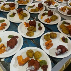 Plated starters ready to be served. This plate includes veg lollipops and other crispy appetizers, perfect for kicking off a meal at any event.