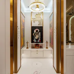 The mandir doors open to reveal the serene space within. The design features a custom-carved Shrinathji idol, authentic paintings of Radha ji, and elegant brass lamps.