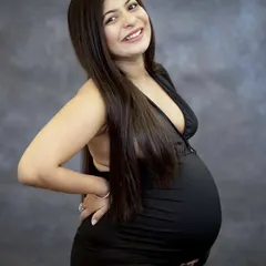 A classic portrait is always a beautiful choice. With a simple backdrop and professional lighting, we can focus entirely on your happy glow. This momma-to-be's radiant smile says it all.