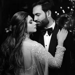 A timeless black and white close-up of a couple in a tender embrace. The classic editing style adds a layer of intimacy and drama to this glamorous evening portrait.