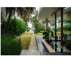 A pathway designed as a journey. Here, stepping stones guide you through a lush garden alongside a tranquil water lily pond, leading you from the natural landscape directly into the heart of the home.