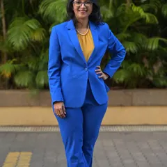 A photo of me in a blue suit. My mom taught me a life-changing lesson: the real competition is with yourself, not others. This mantra helped me score 100% in PCM and drives me to give my 100% in everything I do.