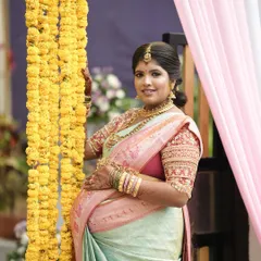 A lovely photo of the client by a curtain of marigolds, her smile radiating pure joy.