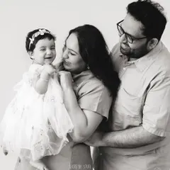 The same moment of joy, in timeless black and white. Stripping away the color often enhances the emotion, making the connection between the family members the central focus of the photograph.