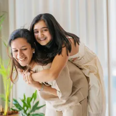A fun piggyback ride in the living room! These sessions are all about capturing the playful, energetic moments that make your family unique.