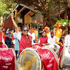 A moment of joy and pride during the Shobha Yatra. This dhol player's expression perfectly captures the festive atmosphere of the cultural parade.