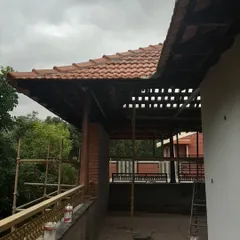 A similar angle of the roof restoration, highlighting the blend of traditional roofing with the underlying structure.