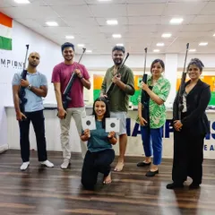 A one-time experience session is a great way to have fun with friends. Here's a group showing off their targets after a session of friendly competition and learning.