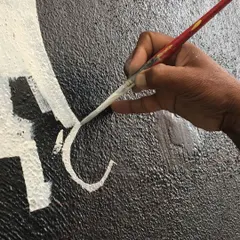 Precision in every stroke. This shot captures the focus and skill involved in hand-painting intricate designs, ensuring a flawless finish for our clients.