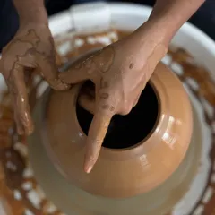 There is a unique peace that comes from working with clay. This moment captures the connection between hands and earth, a feeling of being both at war and at peace as you shape something new.