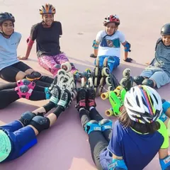 The friendships and teamwork forged on the rink are just as important as the skills learned. This circle of skaters represents the strong community we build at our academy.