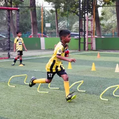 A player navigates a speed and agility course, weaving through hurdles and cones. This type of conditioning drill is a core part of my training program to build explosive players.
