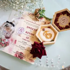A beautiful flat lay of the wedding details. The invitation, the ring box, perfume, and flowers all come together to tell the story of the day before it even begins.