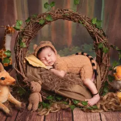 A variation of the tiger costume shoot, this time with a different jungle backdrop featuring a plush giraffe.