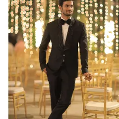 For a formal reception or black-tie event, I designed this sharp black tuxedo. The standout feature is the custom embroidered shawl lapel, which adds a unique, luxurious detail to a timeless silhouette.