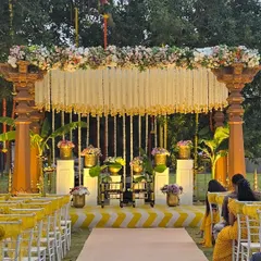The complete Haldi ceremony setup with guest seating. The yellow and white color scheme is carried through from the stage to the chair decor, creating a cohesive and bright atmosphere.