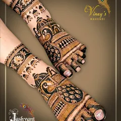 This striking feet design features large peacock motifs with detailed feather work. The jhumka-like patterns on the ankles add a festive touch.