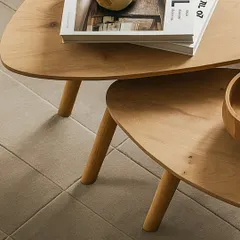 A closer look at the craftsmanship of the nested tables, showing the grain of the wood and the clean joinery of the legs. This piece is designed to be both beautiful and durable, perfect for everyday use.