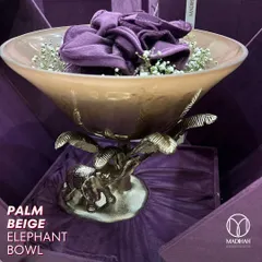 The Palm Beige Elephant Bowl adds a touch of glamour to your home decor. The stunning elephant design and sturdy metal base make it a piece that exudes sophistication.