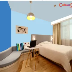 A color visualizer mock-up showing a blue accent wall in a guest room. Our free color consultation can help you explore endless possibilities and choose a palette that perfectly reflects your personal style.