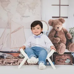 This little gentleman is ready to set sail. Our nautical traveler theme is filled with charming props like vintage suitcases, model ships, and world maps for an adventurous photoshoot.