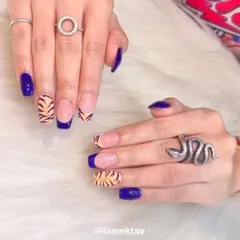 A fierce and trendy design combining bold blue nails with tiger print French tips. This is a great example of how I mix different styles to create a unique look.
