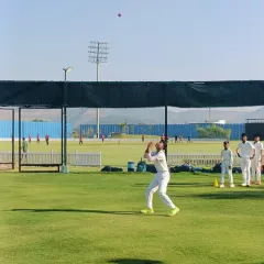 Eyes on the ball. A player positions himself perfectly to take a high catch during a fielding practice session.