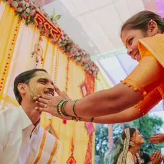 A genuine smile from the groom as a relative applies turmeric paste during the Haldi ceremony.