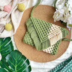 Inspired by nature, this two-toned green and cream macrame clutch is one of my personal favorites. 🍀 It's a versatile bag that you can use as a clutch or attach the strap to wear as a sling. The fringe detail adds a lovely boho touch.