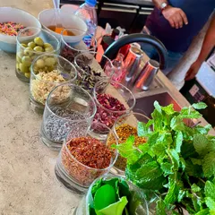 A selection of fresh and dried garnishes ready for service. I use a wide variety of ingredients like fresh mint, kaffir lime leaves, dried flowers, and spices to create unique flavor profiles.