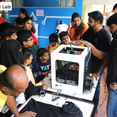 During a RoboExpo at our Marathahalli Maker Lab, our team explains the principles of 3D printing to a curious crowd of adults and children, showcasing a key tool in modern prototyping.
