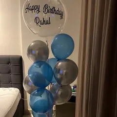 A simple and stylish birthday bouquet for Rahul. This arrangement includes a personalized clear bubble balloon paired with classic blue and silver balloons, perfect for a surprise at home.