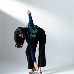 Directing the model to create dynamic shapes and movements that complement the fashion. The white background keeps the focus on the product and the pose.
