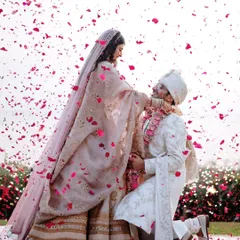 The beautiful varmala ceremony, where the groom kneels amidst a shower of petals. It's these emotional, unscripted moments that we love to capture.