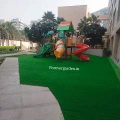 I create safe and fun play areas for children. This installation features my shock-absorbent artificial turf around a playground set, providing a soft landing surface that stays green all year.