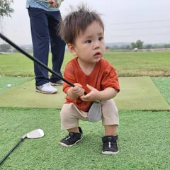 A future champion in the making. This toddler looks ready to take his first swing, showing that the love for golf can start at any age.