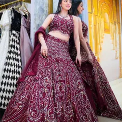 A full-length shot of a stunning maroon bridal lehenga. When I model for wedding couture, the goal is to showcase the intricate details and the overall grandeur of the outfit.