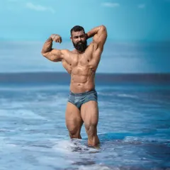 My physique today, captured at the same beach. This transformation is the result of years of dedication, overcoming injuries, and a relentless pursuit of progress.